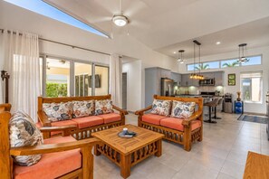 A spacious living area with a sofa set, a wooden coffee table, and a kitchen in the background. - Private Pool Villa with Ocean Views in Casa Linda (Sosúa)