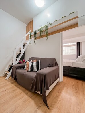A modern living space with a sofa, a staircase, and a bed. - Charming Apartment 5 Min From Copacabana Beach - Sf415 (Rio de Janeiro)