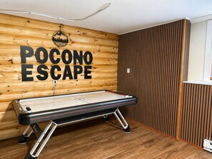 A pool table in a room with wooden paneling and a sign that reads 'POCONO ESCAPE'. - Spacious 4BR Pocono Chalet - Hot Tub, Barrel Sauna & Game Room (Pocono Summit)
