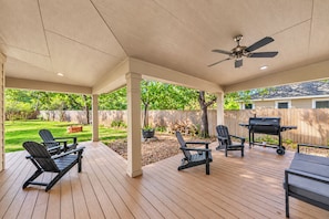 An outdoor patio with a covered area, wooden deck, ceiling fan, and outdoor seating. - Walton: 60 Second Drive to Texas A&M (College Station)