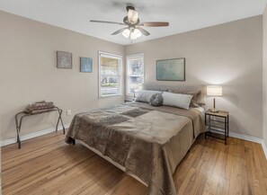 A bedroom with a bed, a standing heater, a ceiling fan, and a window with blinds. - Walton: 60 Second Drive to Texas A&M (College Station)
