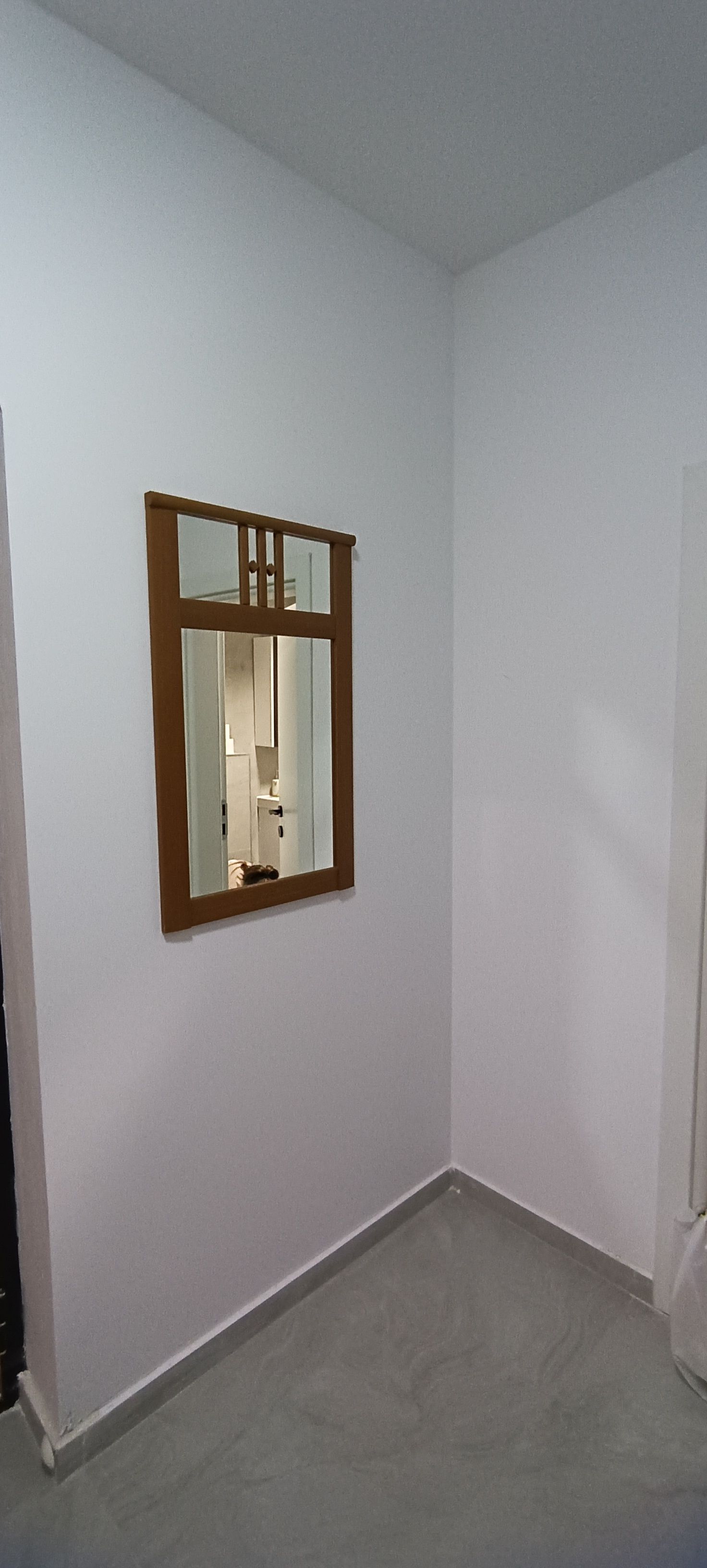 A room with a single window and a door.