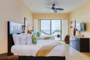 A hotel room with a bed, a desk, a television, and a view of the ocean. - Oceanfront Studio in a 5 star Garza Blanca Resort, Puerto Vallarta, Mexico (Puerto Vallarta)
