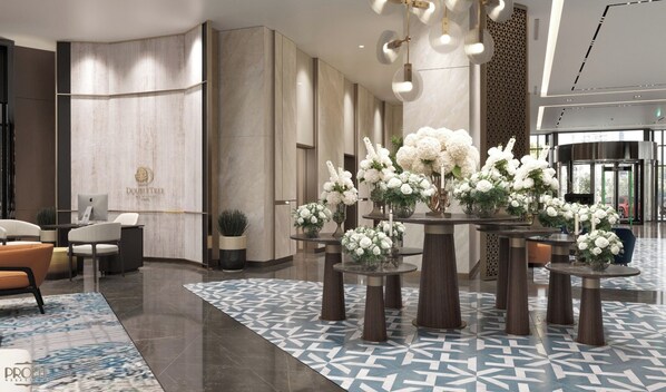 A modern hotel lobby with a reception desk, seating area, and decorative floral arrangements. - Doubletree By Hilton Diyarbakir (Diyarbakir)
