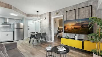 A modern living space with a kitchen, dining area, and seating area.