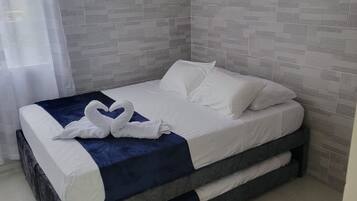 Un dormitorio moderno con una cama, un cojín azul decorativo y un cojín con forma de cisne.