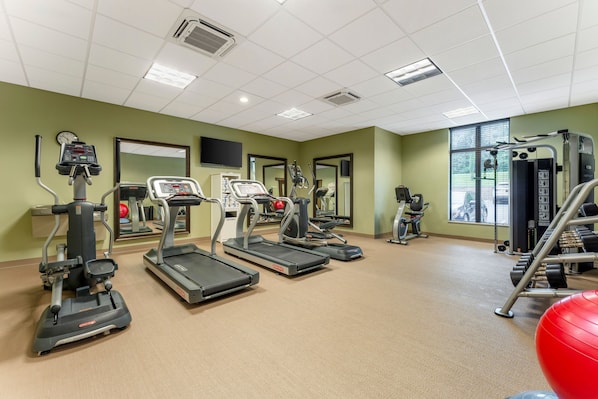 A gym with treadmills, elliptical machines, and weight equipment. - Spacious Studio w/ Kitchen | Pool + Hot Breakfast (Warrendale)