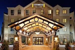 A Staybridge Suites hotel with a stone facade, large entrance, and a covered patio area. - Accessible 1BR Suite | Roll Shower & Hot Breakfast (Warrendale)