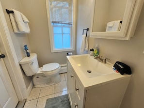 Ein Badezimmer mit Toilette, Waschbecken und Spiegel.