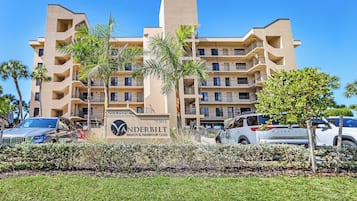 A multi-story hotel with a sign reading 'GULFSIDE VANDERBILT BEACH & HARBOUR CLUB' and the number '9301'.