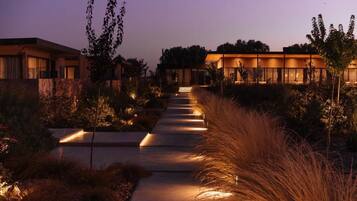 A pathway leading to a modern building complex with multiple structures.