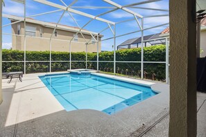 A swimming pool with a glass enclosure, surrounded by a hedge and a bench. - Disney Princess Suite, Family Home, Sleeps 12 (Davenport)
