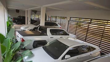 A parking garage with multiple cars parked.