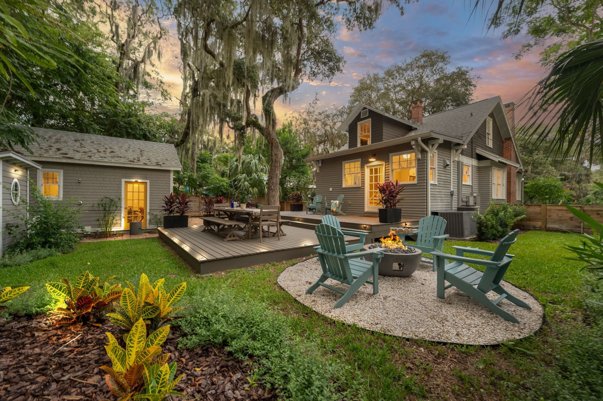 A residential property with a deck, outdoor seating, and a fire pit.