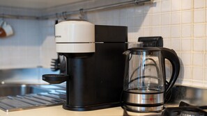 A coffee maker and a glass carafe on a kitchen counter. - [Isola - Porta Nuova] Elegant 1BDR with Balcony (Milano)