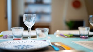 A dining table with plates, glasses, and cutlery. - [Isola - Porta Nuova] Elegant 1BDR with Balcony (Milano)