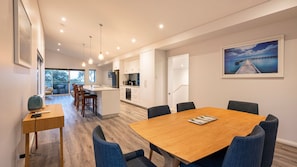 A modern kitchen with white cabinets, a central island, and pendant lighting. - Bay Lookout @ Cape Villas (Dunsborough)