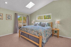 A bedroom with a bed, a nightstand, a window, and a ceiling light. - AC, Luxury, Comfort, Family, Hot tub, Privacy (Sunriver)