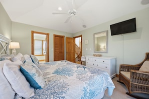 A bedroom with a bed, dresser, chair, and a ceiling fan. - Spacious 5BR Corolla retreat with private pool, hot tub, and game room. (Corolla)