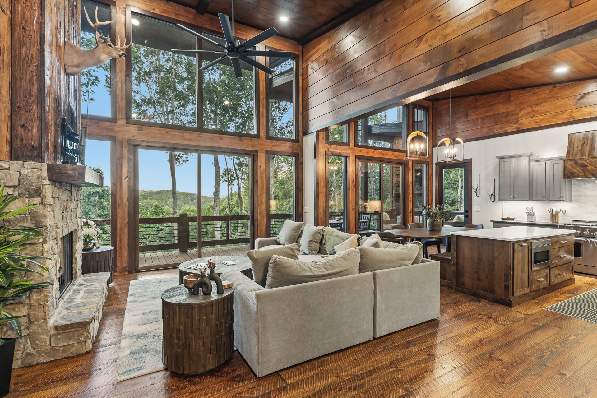 A spacious living area with a stone fireplace, a large sofa, and a dining table.
