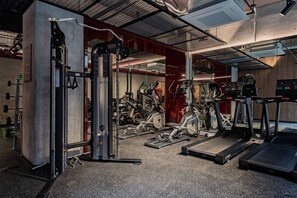 A gym with various exercise equipment including a weight machine, treadmills, and stationary bikes. - Gallery-Style Loft, Workspace & Prime Location (Mexico City)