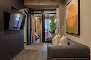 A modern interior with a sofa, a flat-screen TV, and a large abstract painting. - 3 Private Apartments Near Reforma Tabacalera (Mexico City)