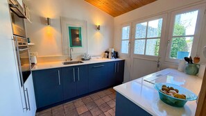 A modern kitchen with a sink, cabinets, and a countertop. - Two-story village house in the village of Ars (ARS EN RE)