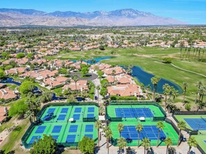 A residential area with houses, a golf course, and tennis courts. - Desert Falls Country Club Villa - Remodeled 2BR- Golf, Pickleball, Tennis & Pool (Palm Desert)
