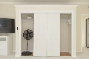 Generous closet with hanging and shelf space for convenient clothing and luggage storage. A standing fan is also provided for added comfort. - Modern 3BR La Jolla Home w/ Panoramic Ocean Views (La Jolla)