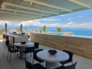 A rooftop terrace with outdoor seating, a pool, and a view of the sea. - Vrbo Property (Bucerías)