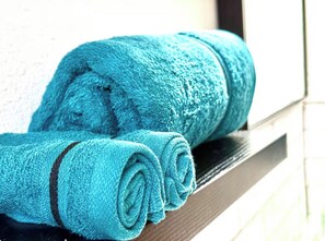 A window sill with rolled towels. - Bright and Cozy Studio Retreat with Classic Dallas Charm (Dallas)