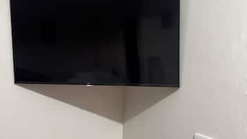 A flat-screen TV mounted on a wall in a corner.