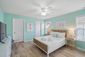 A bedroom with a bed, a ceiling fan, a window with blinds, and a door. - Seaglass! Folly 30 night Minimum Stay-Close to Beach & Town- (Folly Beach)