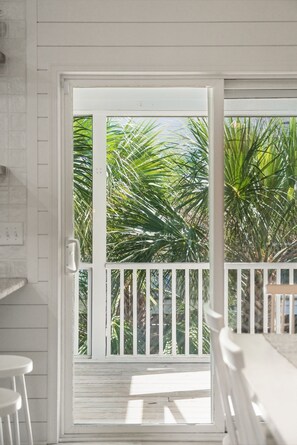 A white door with a white railing leading to a balcony with palm trees. - Seaglass! Folly 30 night Minimum Stay-Close to Beach & Town- (Folly Beach)
