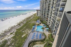 A hotel with a pool, beach, and ocean view. - Edgewater T2 703 - 3 Bedrooms! (Panama City Beach)