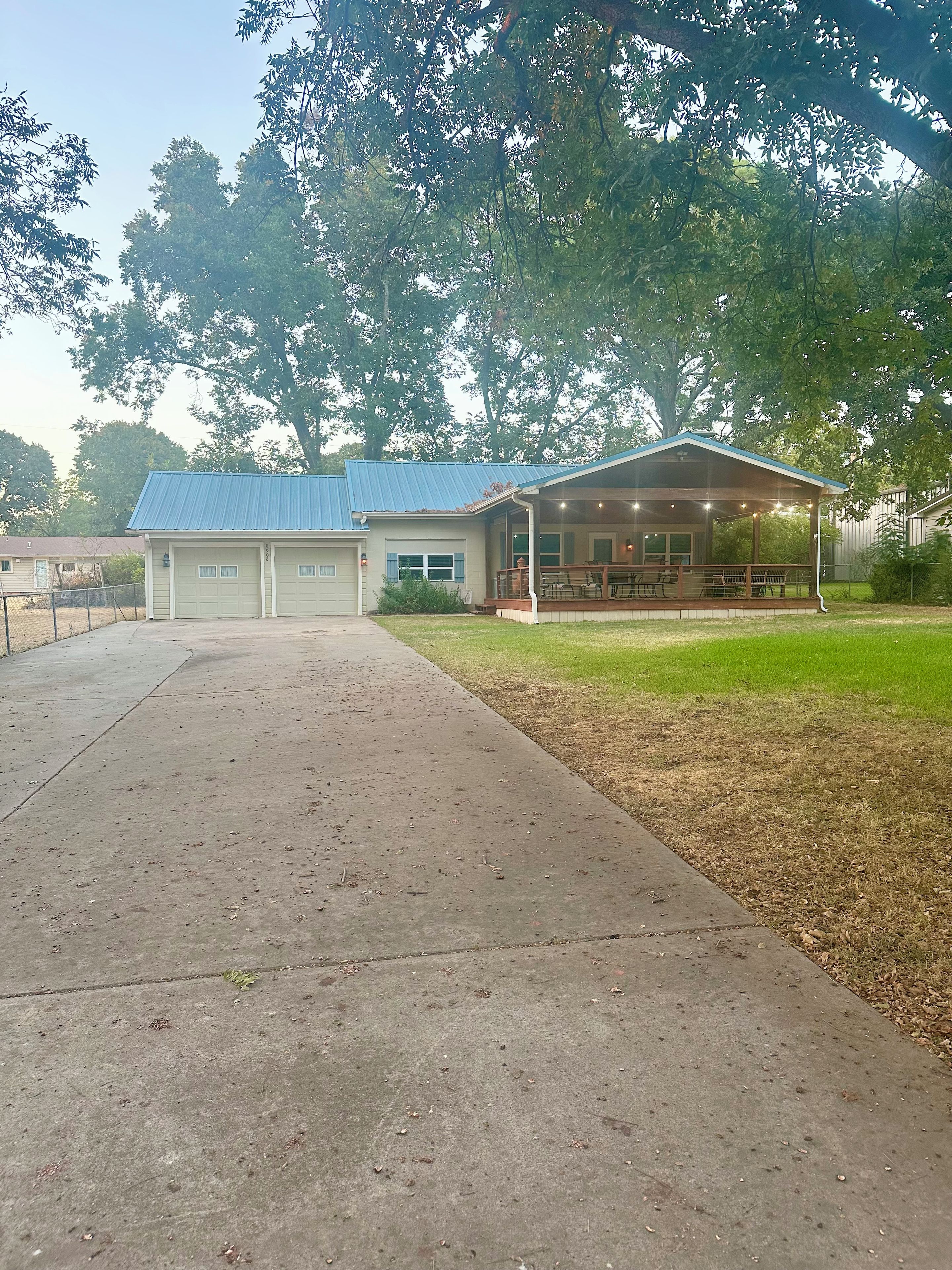 A building with a covered porch and a garage.