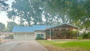 A building with a covered porch and a garage.