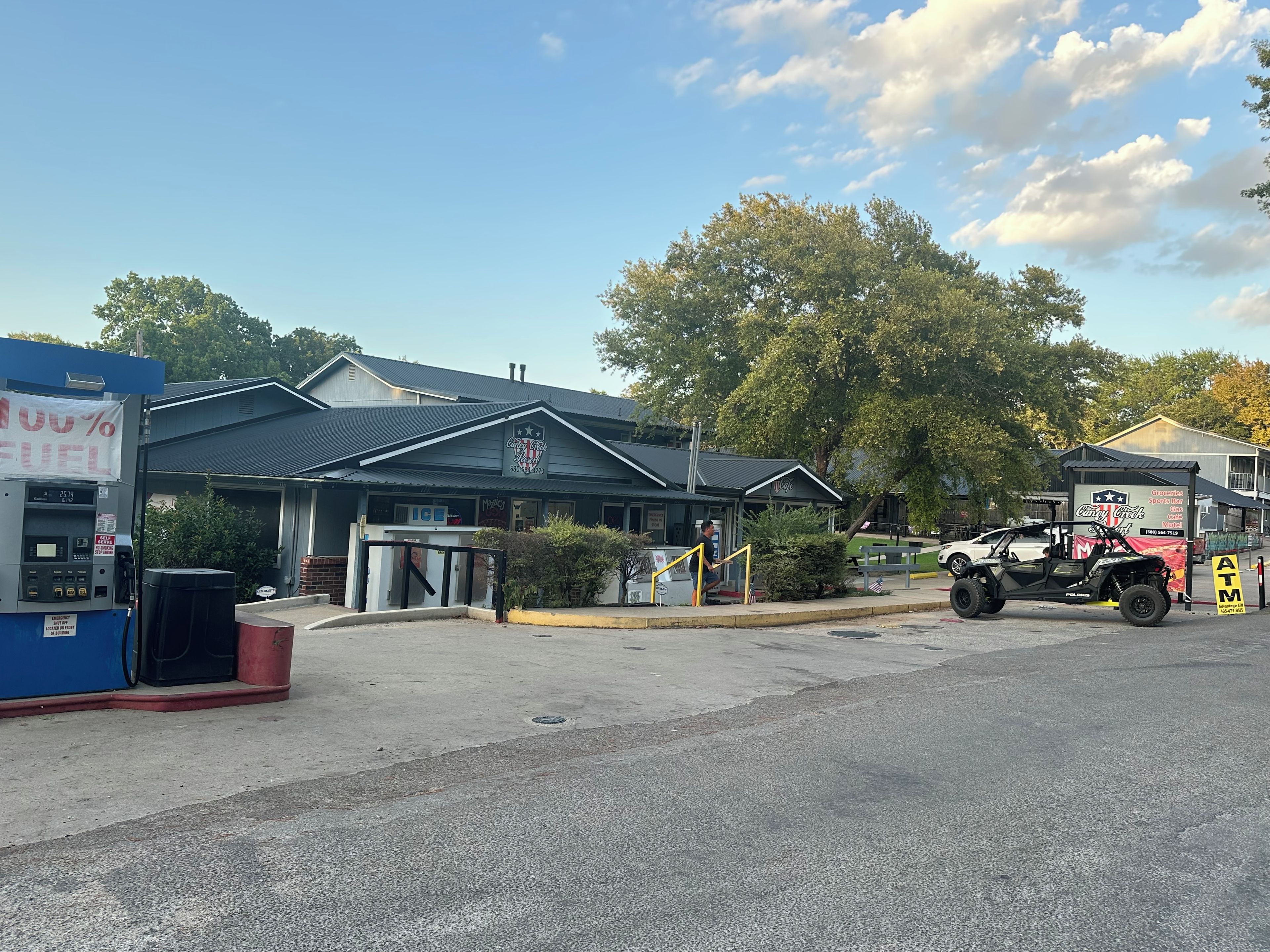 A gas station with a fuel pump, a convenience store, and a sports bar.