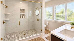 A modern bathroom with a glass-enclosed shower, marble walls, a white sink, and a window with blinds. - Work & Relax Retreat, Pool, Wifi, Stocked Kitchen (Nashville)
