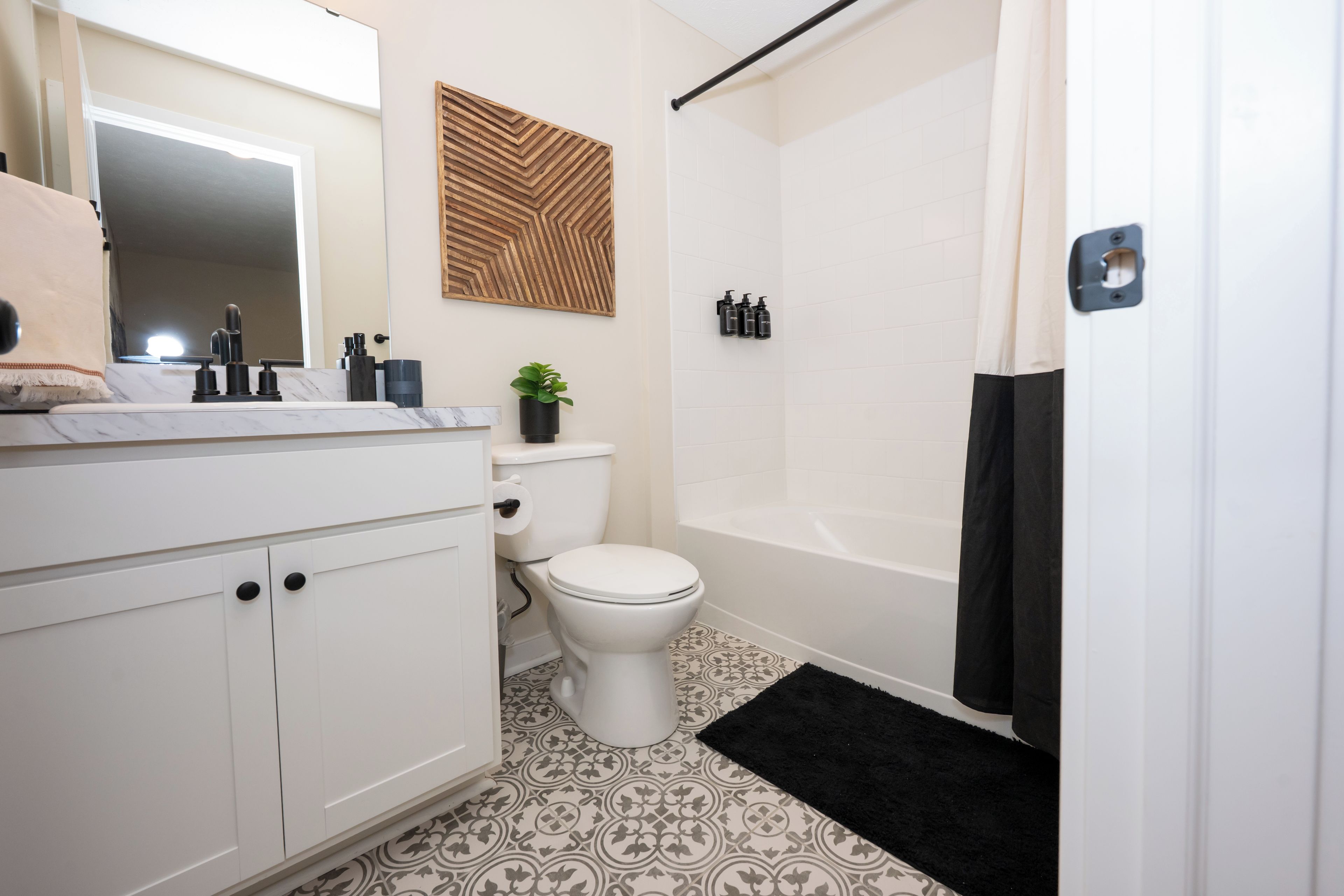 A bathroom with a toilet, sink, and bathtub.