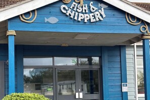 A building with a sign reading 'Fish & Chipspery' above the entrance. - Cabin Sleeps 6 with Dishwasher (Skegness)