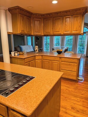 A kitchen with wooden cabinets, granite countertops, and a built-in stove.