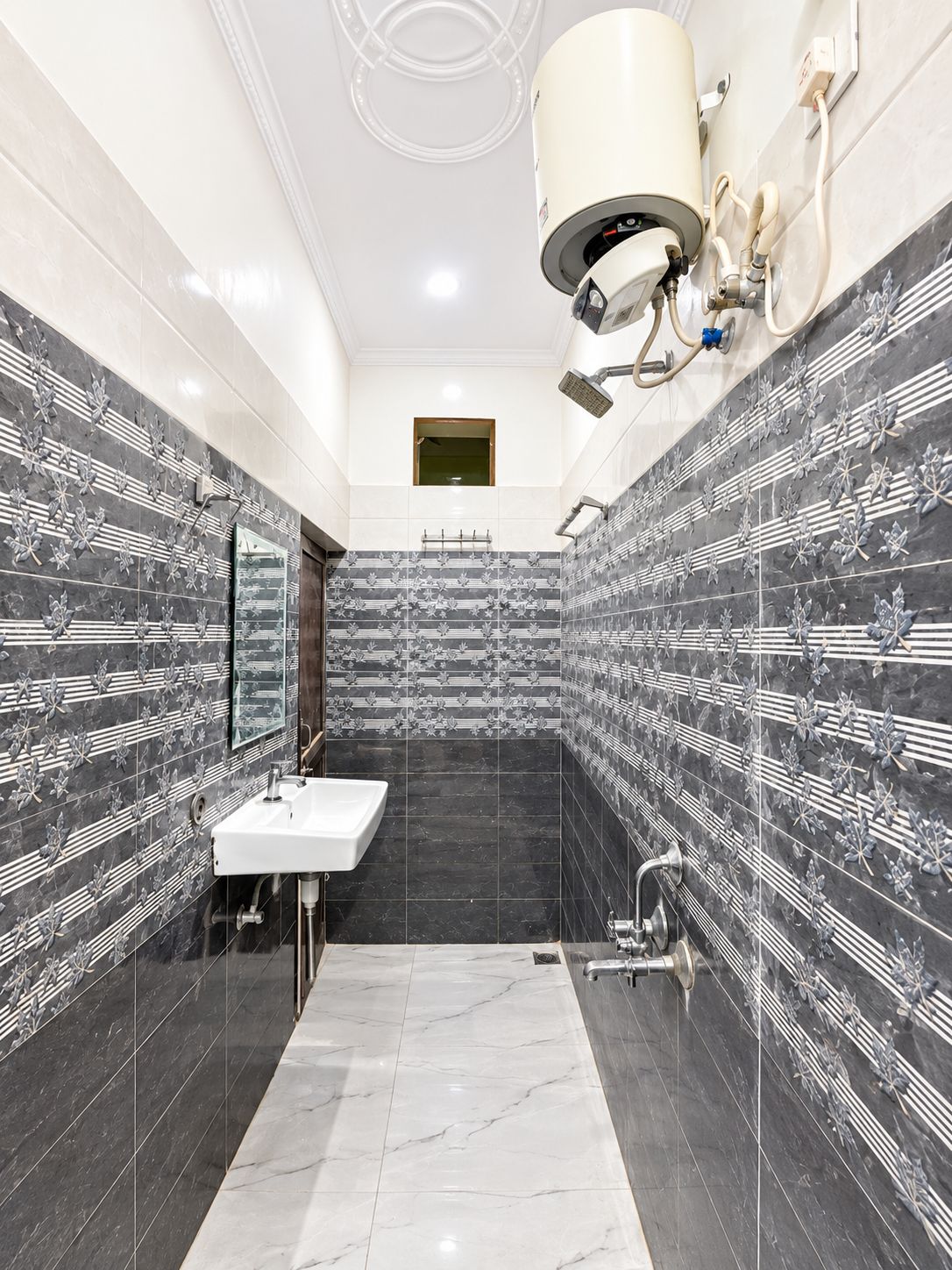 A bathroom with a white sink, a mirror, a shower, and a toilet.
