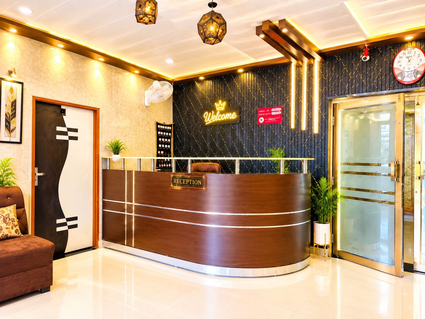 A reception desk with a 'RECEPTION' sign, a 'Welcome' sign, a clock, and a check-in counter.