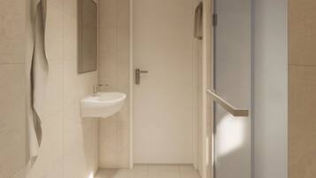 Un baño moderno con un lavabo blanco, un espejo y una puerta que da a otra habitación.