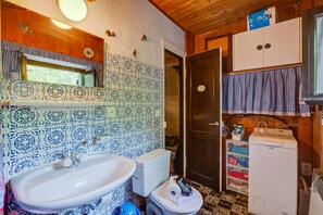 Un baño con lavamanos, inodoro y cabina de ducha.