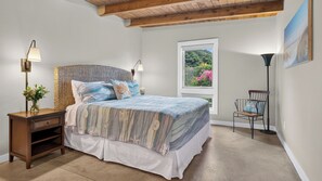 A bedroom with a bed, bedside tables, a window with a view, and a chair. - The Grey Piper by Avantstay Ocean Views + Fire Pit + BBQ Walk to Beach (Arch Cape)