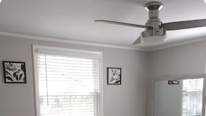 A bedroom with a bed, a ceiling fan, a window with blinds, and a dresser. - Cozy home in Ardmore Winston-Salem pet friendly, close to hospital & University (Winston-Salem)