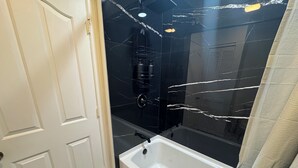 Un bagno con una vasca, una doccia e un water.