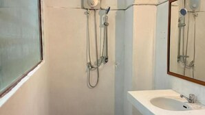 A bathroom with a shower, a sink, and a mirror. - White Castle (Krong Siem Reap)